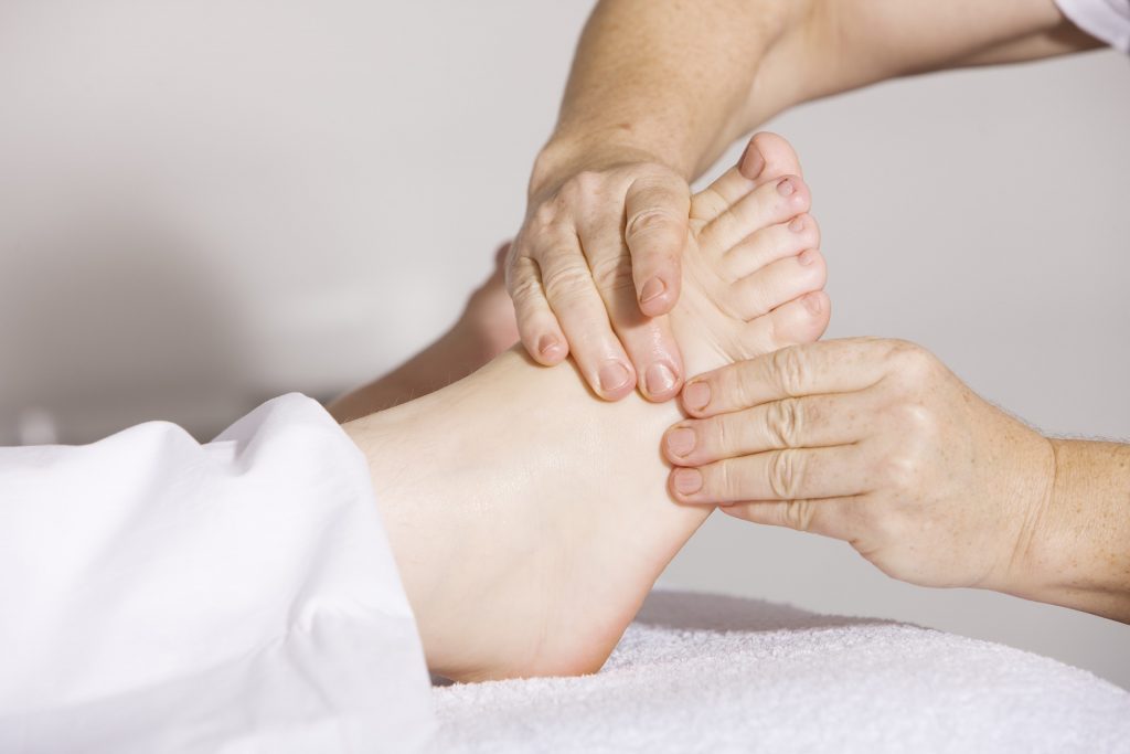A foot zoning practitioner giving a massage