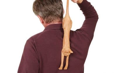 Man scratching his back using the best back scratcher